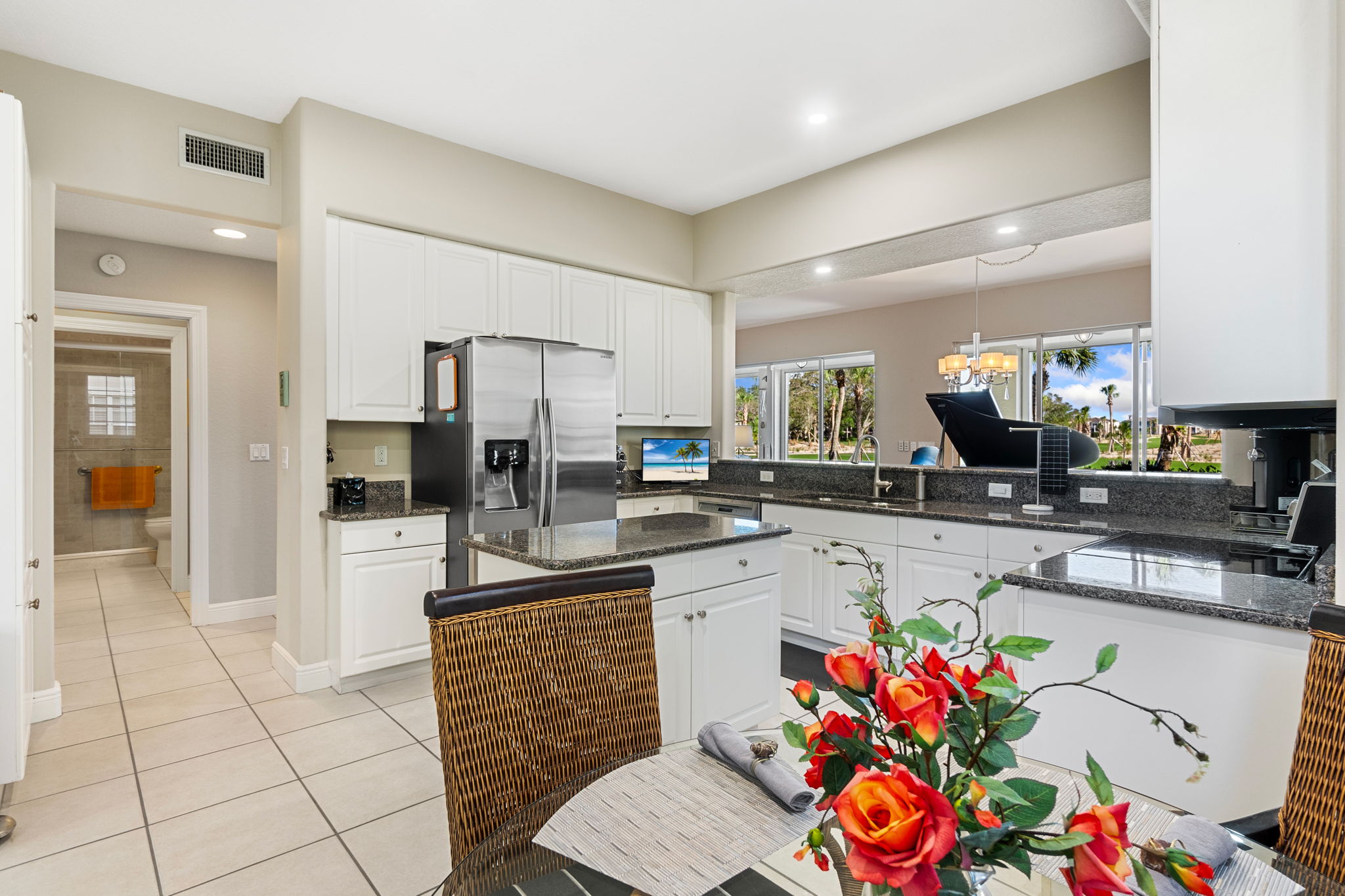  A modern kitchen with a stylish table and chairs, designed for comfort and functionality in dining.