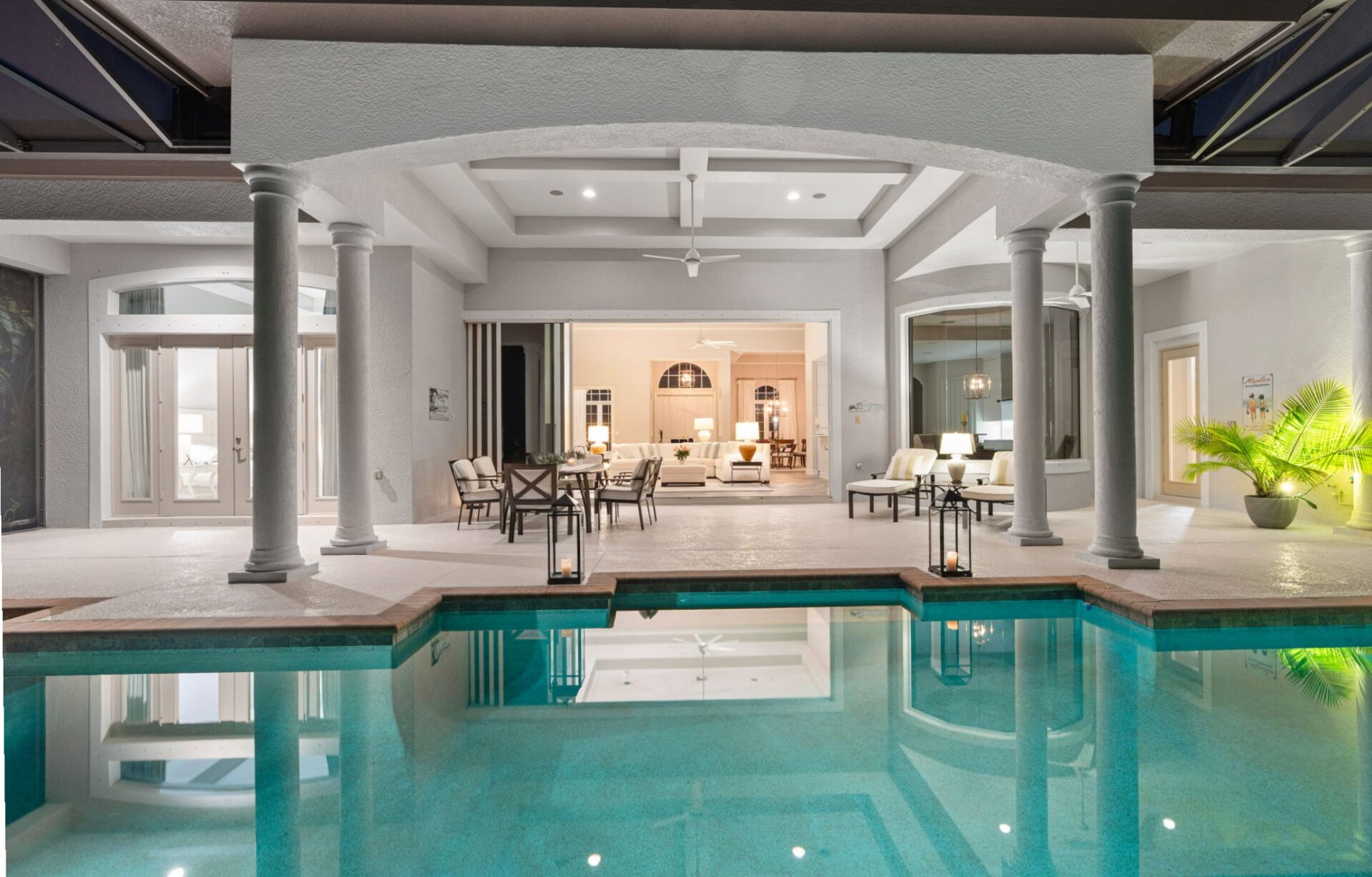 Naples Luxury Home Pool & Outdoor Living Space at Twilight Luxury Naples Florida pool and covered lanai at twilight showcasing indoor outdoor living and elegant architectural design