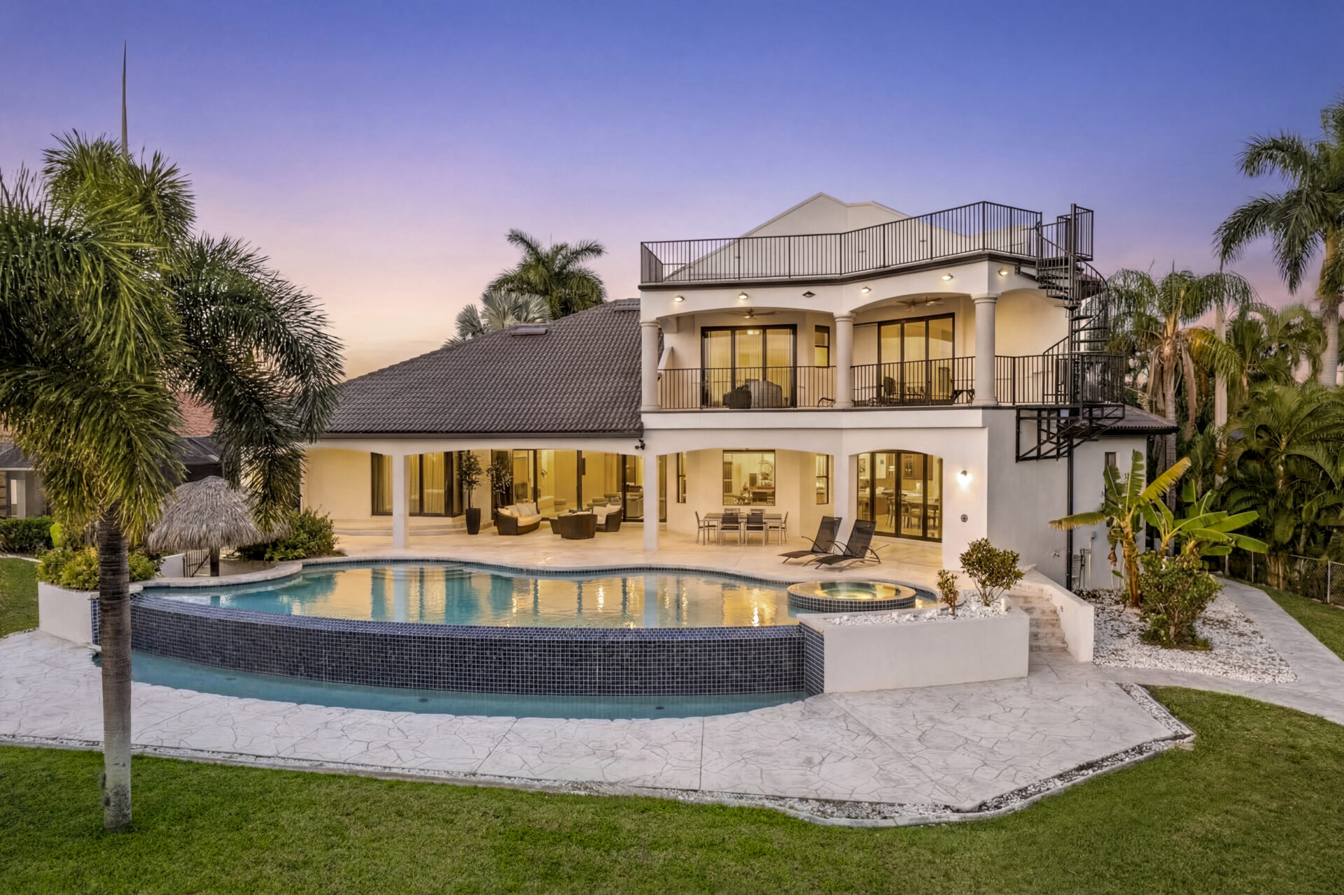 Luxury waterfront home in Cape Coral Florida with direct Gulf access, private boat dock, tiki hut, pool and modern architecture at 4944 Normandy Ct