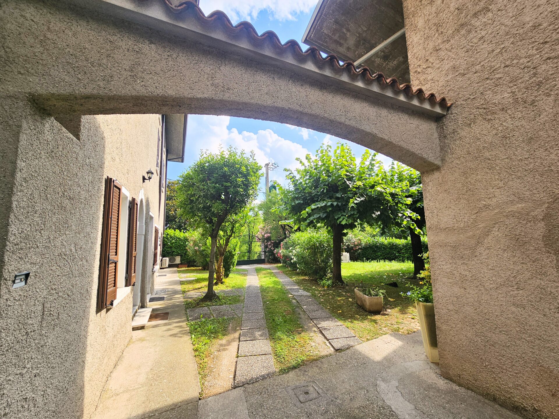 Charming garden entrance of a renovated Italian village home near Desenzano del Garda and Lake Garda, Italy