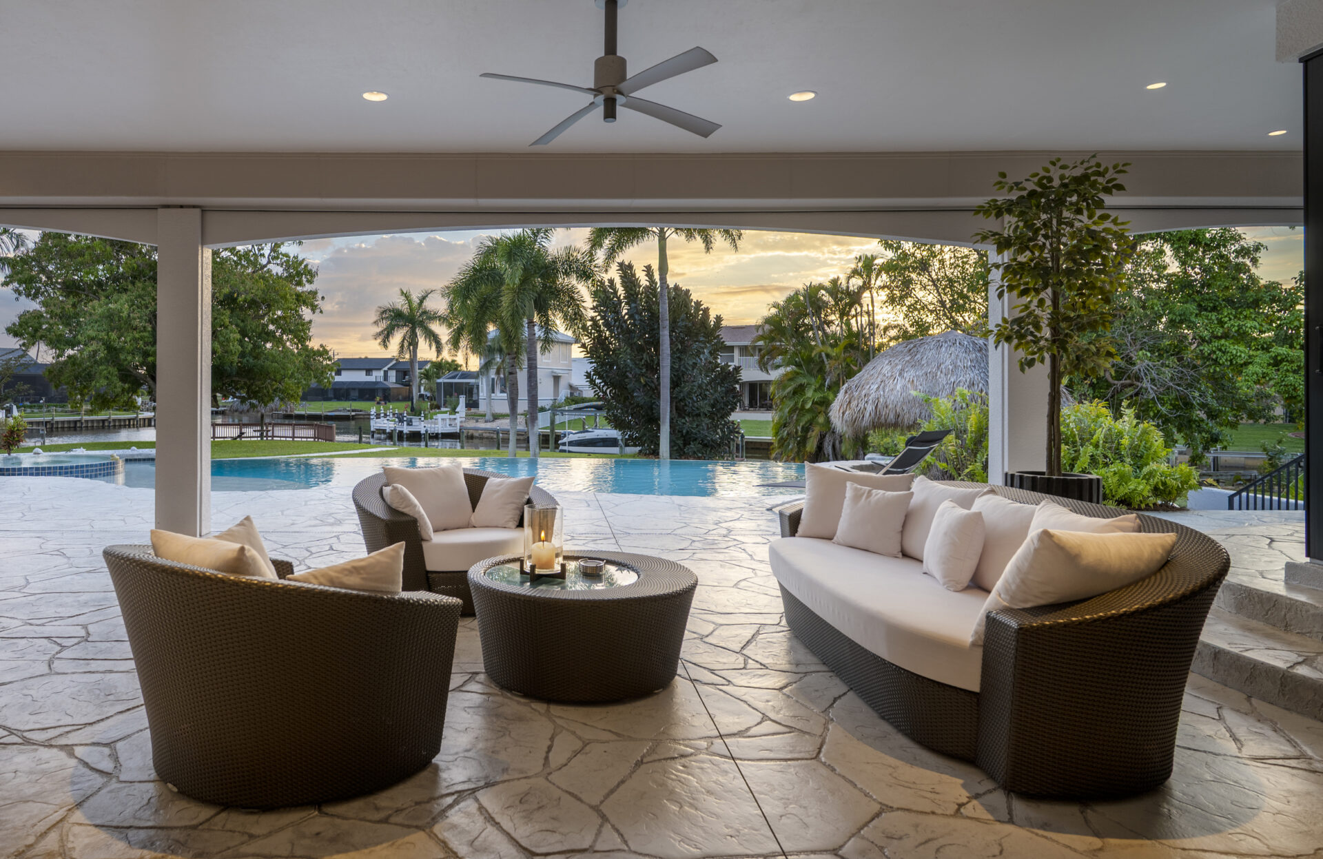 Stimmungsvoller überdachter Terrassenbereich bei Sonnenuntergang mit Blick auf Pool und Wasser in Cape Coral